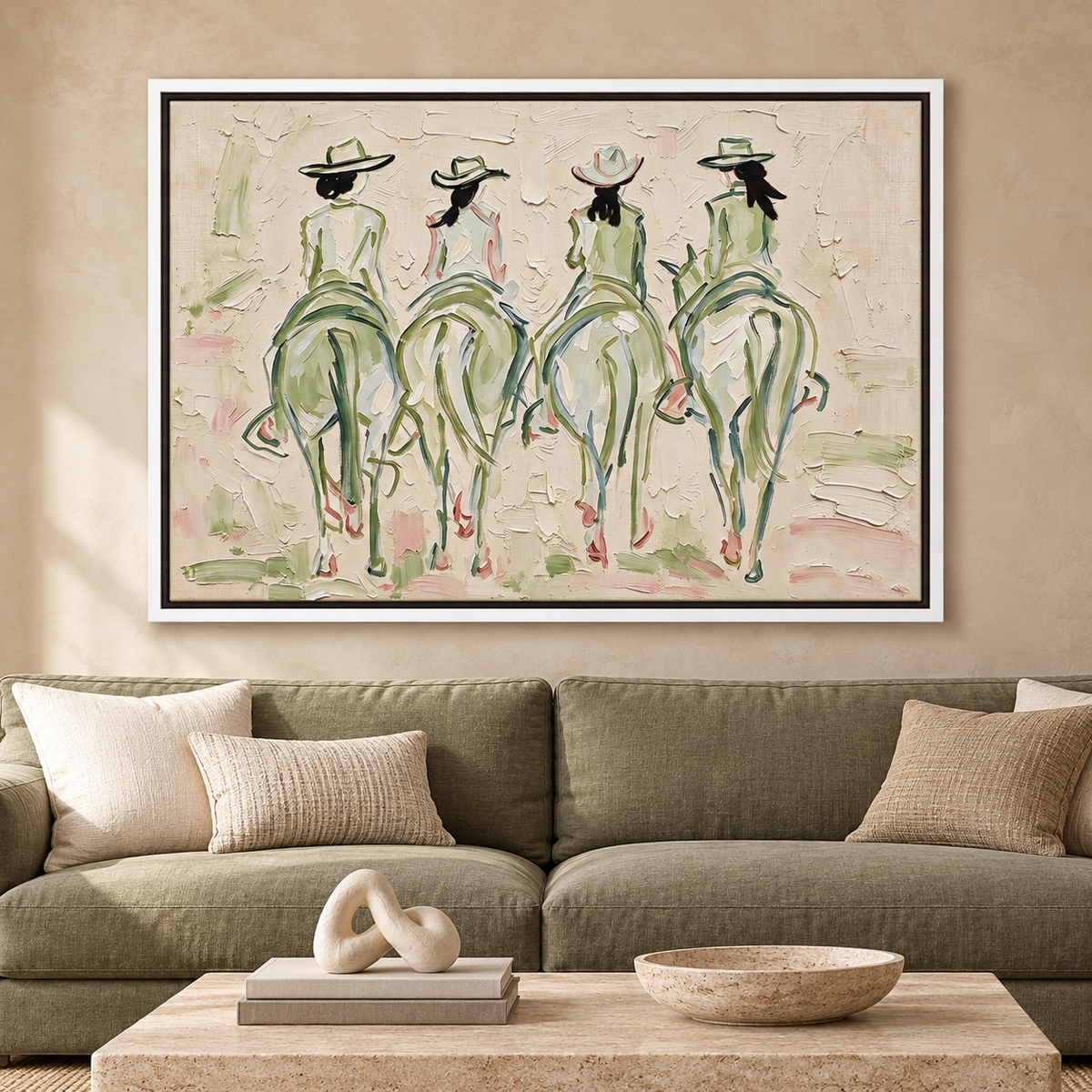 Four cowgirls on horseback seen from behind, with wide-brimmed hats and long dark ponytails, outlined in sage green and pale pink against a cream background, shown in room setting 1.
