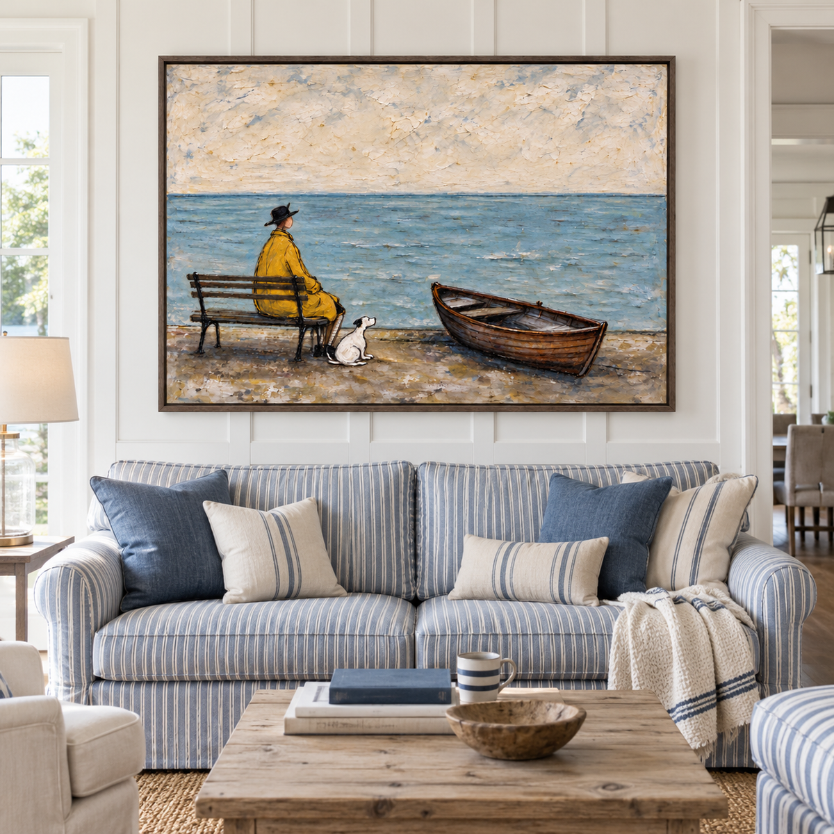 A man in a yellow coat seated on a bench looking out over blue water with a small white dog beside him and an empty wooden rowboat on the beach, shown in room setting 1.