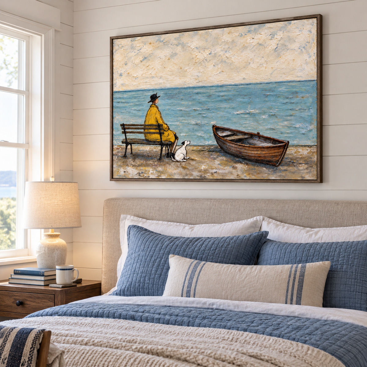 A man in a yellow coat seated on a bench looking out over blue water with a small white dog beside him and an empty wooden rowboat on the beach, shown in room setting 4.