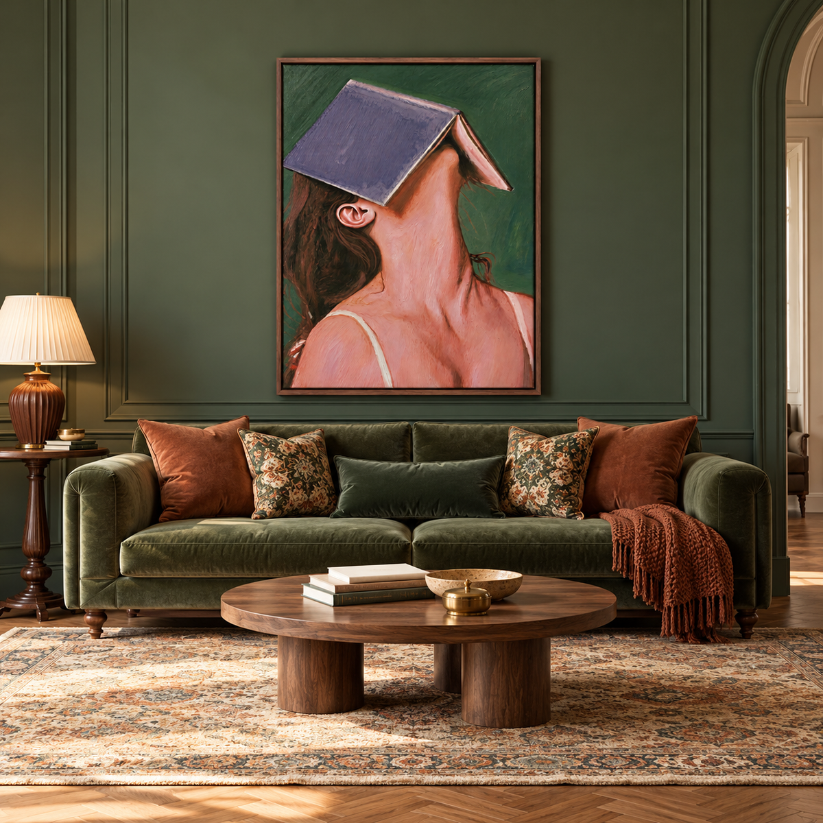 A close portrait of a woman leaning back with a large violet-blue book covering her forehead and eyes against a deep green background, in a living room.
